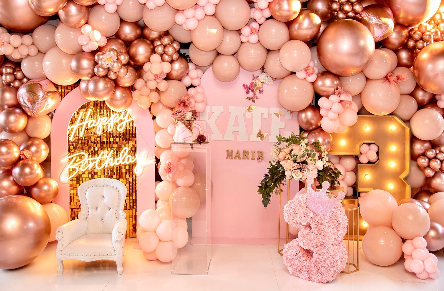 Festive birthday decoration featuring a balloon arch