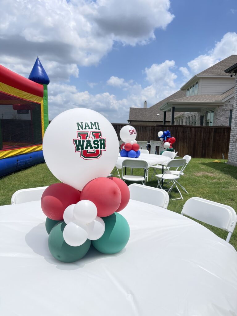 Colorful balloon centerpiece, set on a table at an outdoor event